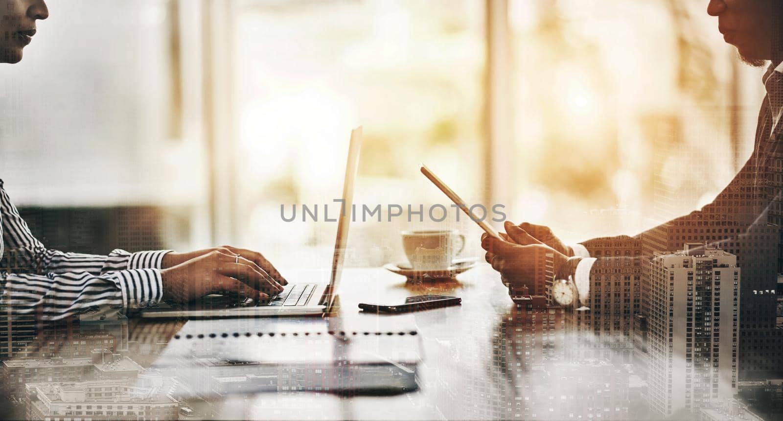 Their devices keep them connected to everything in business. Closeup shot of two unrecognizable businesspeople using digital devices during a meeting in an office. by YuriArcurs