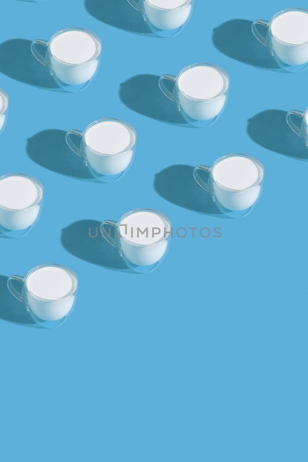 Milk in a glass pattern on a colored background, dairy diet concept. High quality photo