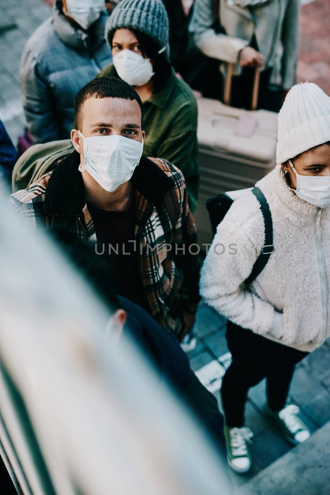 People traveling during covid travel restrictions are waiting for coronavirus testing. Portrait of tourists or travelers walking on stairs in a public airport during a lockdown due to virus outbreak by YuriArcurs