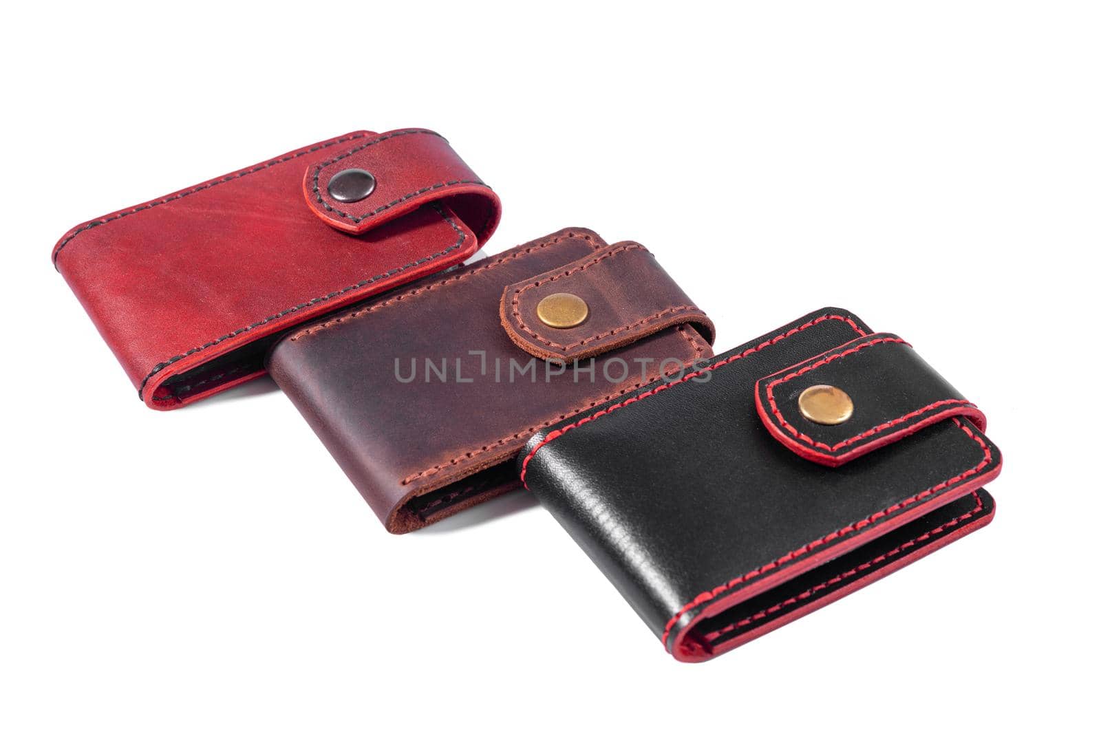 Set of three luxury craft business card holder cases made of leather. Brown and black Leather boxes for cards isolated on white background.