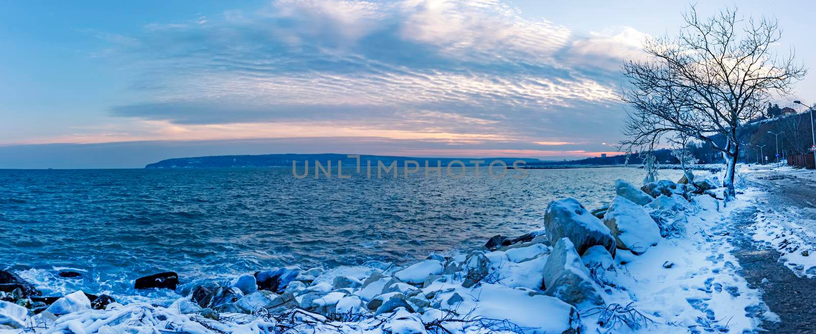 Winter landscape, sunrise, or sunset at the shore. Panoramic view