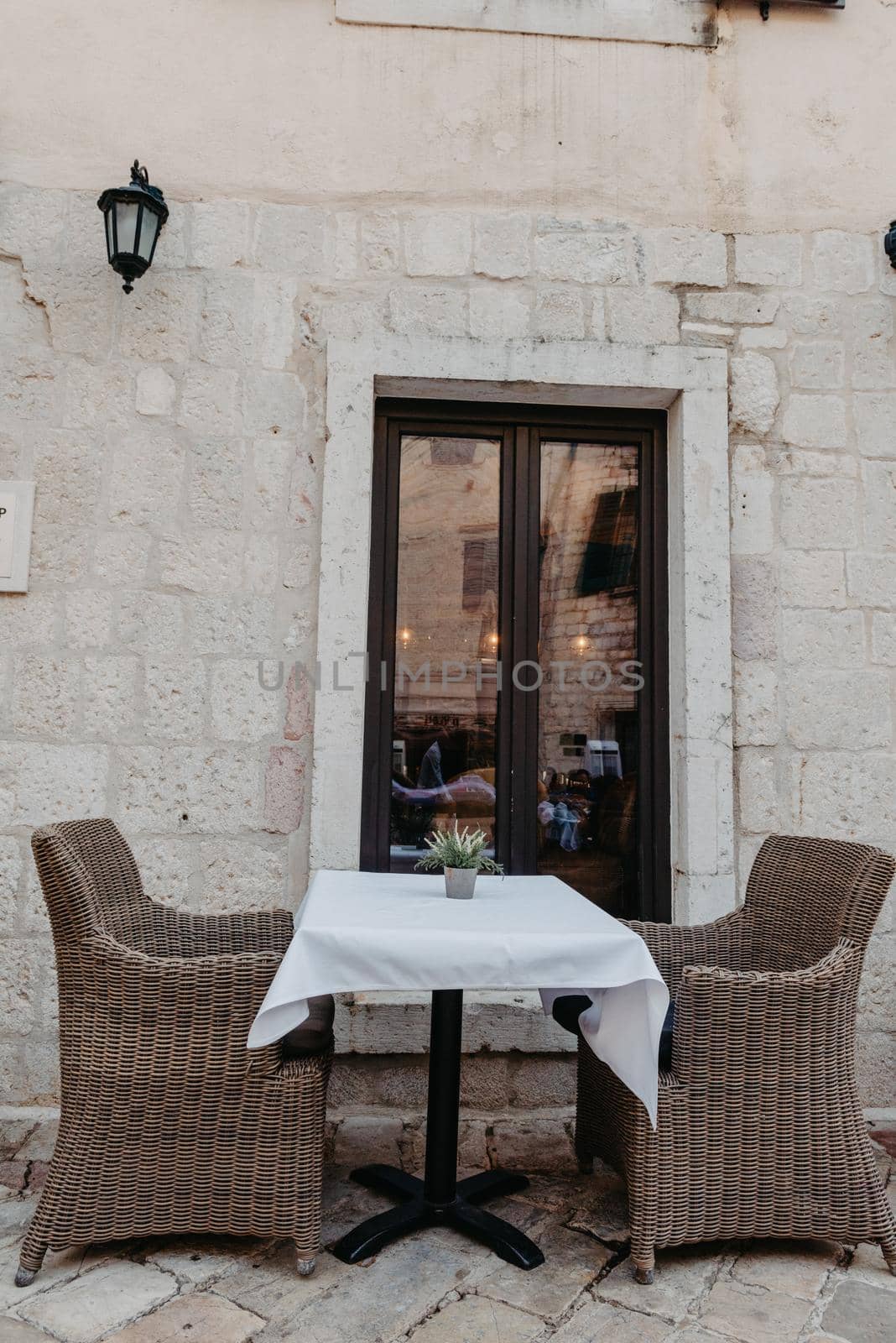 Morning street empty outdoor cafe with traditional wooden chairs waiting for guests or tourists. Cafe terrace in small European city. Summer cafe, empty tables in outdoors cafe in Europe, Coffeeshop, Cafe on the street, outdoors by Andrii_Ko