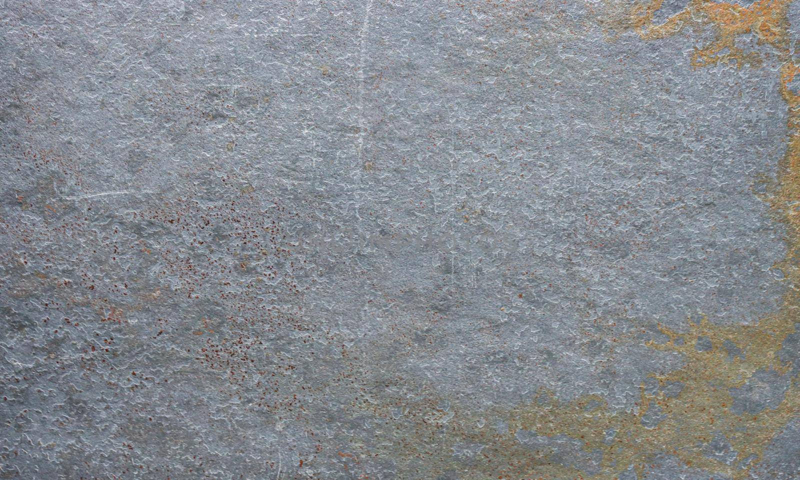 Gray stone surface covered with rust, mold. Close-up photo of an abandoned concrete wall.