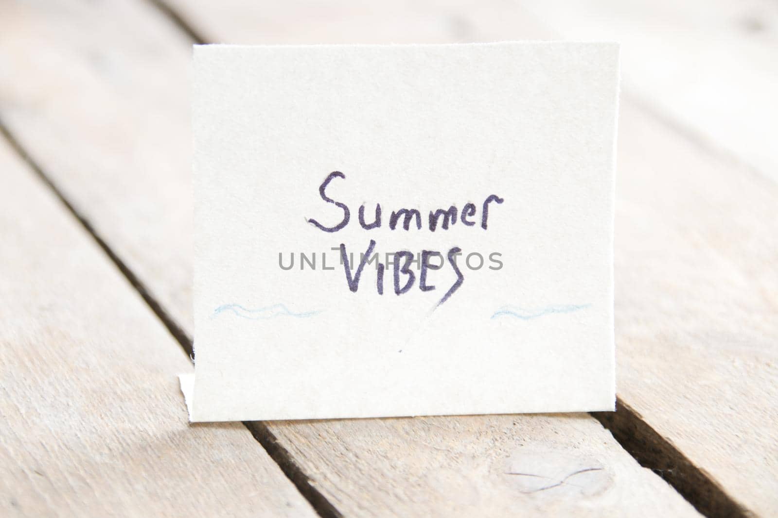 The inscription on a piece of paper summer vibe, vintage background