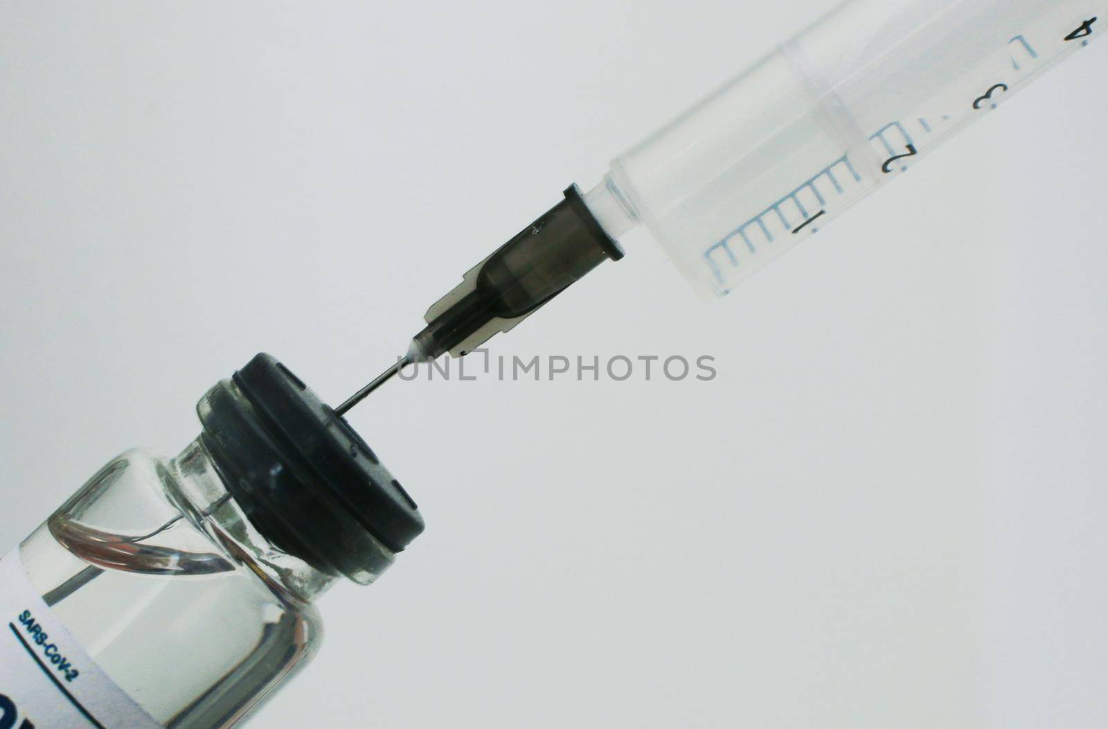 A vaccination syringe and a glass ampoule with a clear liquid. by gelog67