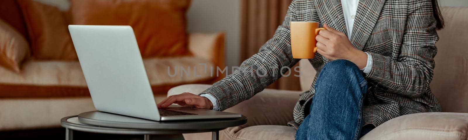 Close up of business woman working laptop and drink coffee sitting in cozy cafe by Yaroslav_astakhov