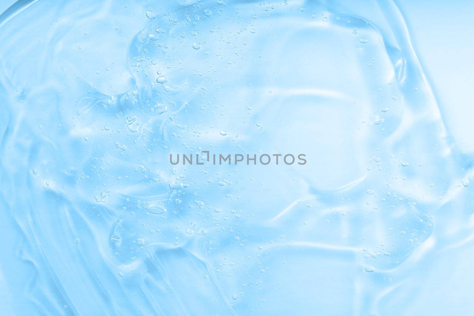 Cream gel blue transparent cosmetic sample with bubbles isolated on white background. Face serum texture. Clear skincare product smudge closeup. Hand sanitizer by photolime