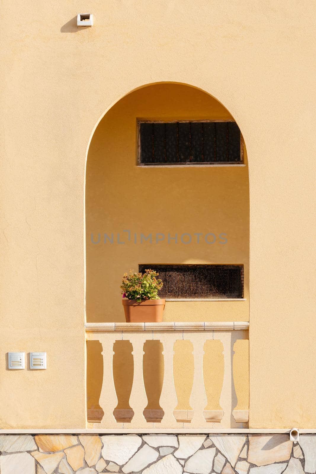 Typical yellow house facade part in italian city near the sea. Mediterranean village style. by photolime