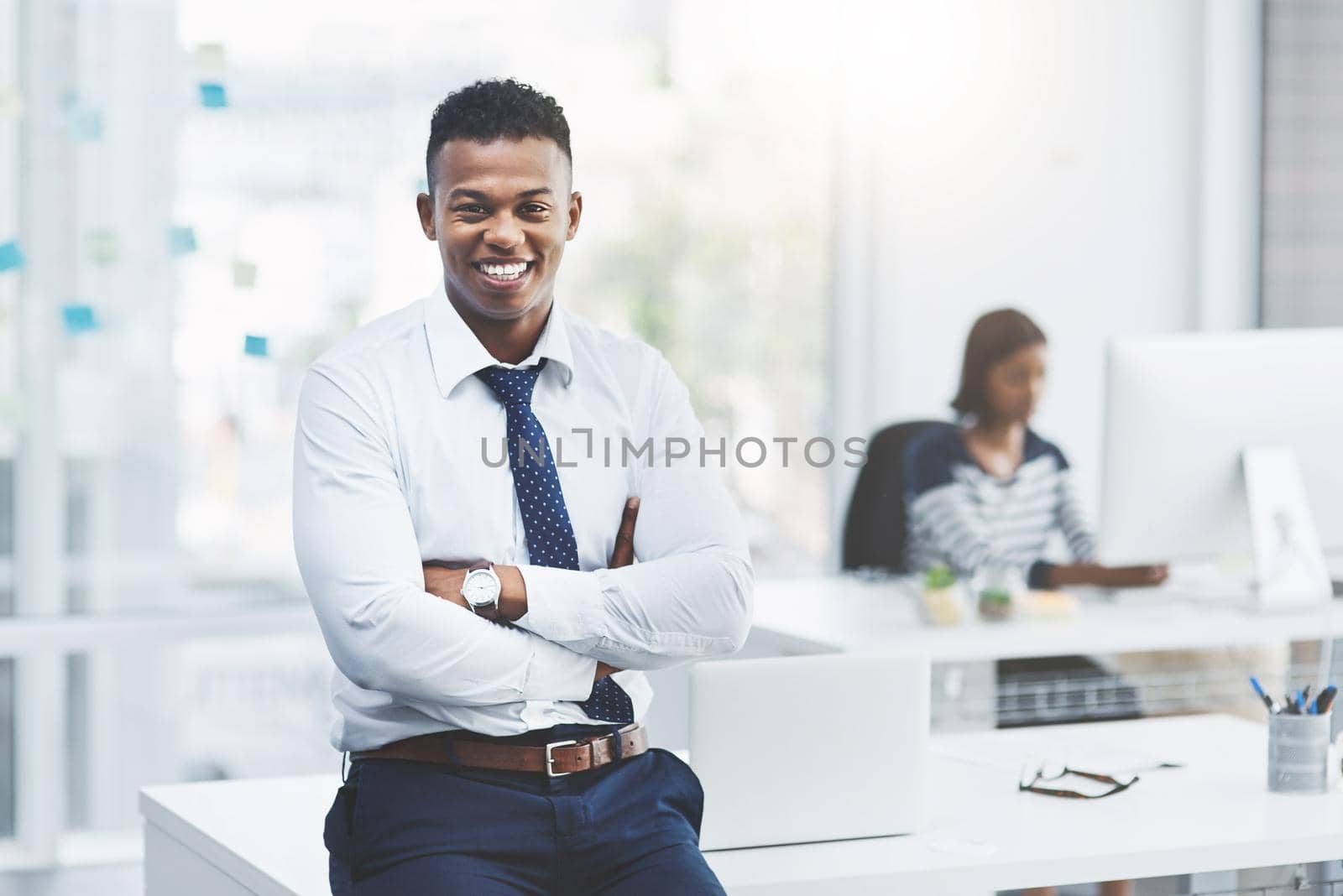 Success always starts in the mind. Portrait of a young businessman standing in his office and posing with his arms crossed. by YuriArcurs