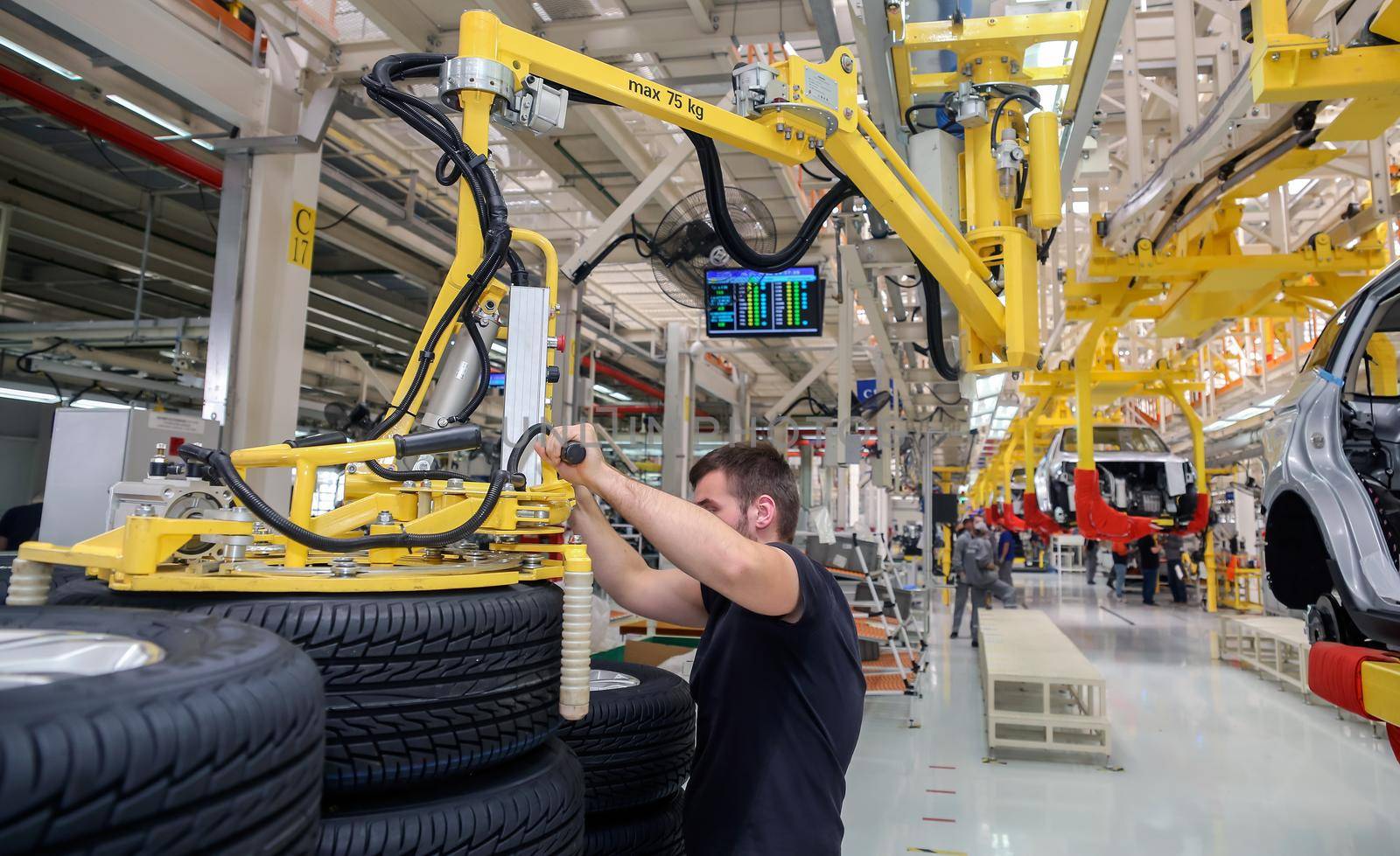 Factory for the production of cars, factory conveyor. Cars are being assembled.