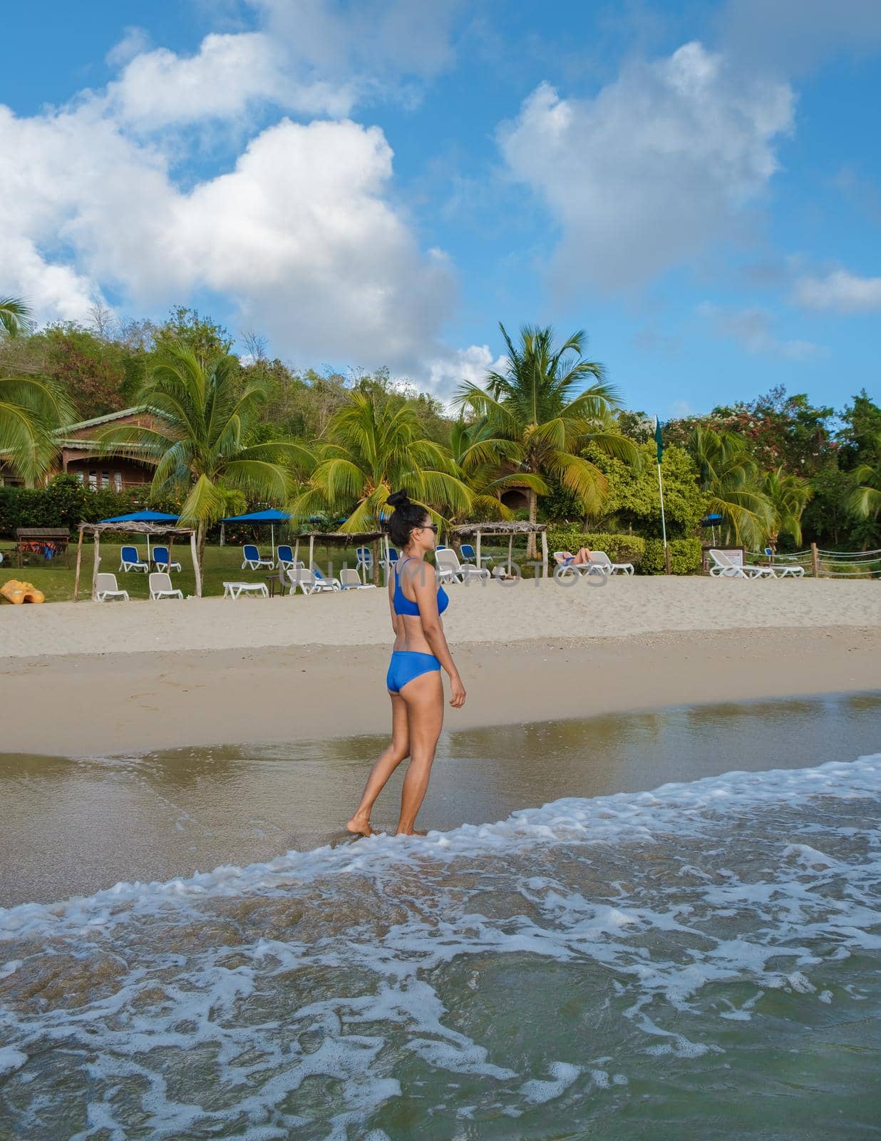 Asian women walking at the beach on vacation Saint Lucia, luxury holiday Saint Lucia Caribbean by fokkebok