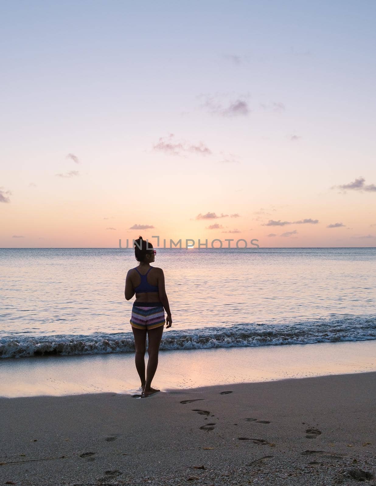 Asian women walking at the beach on vacation in Saint Lucia, luxury holiday Saint Lucia Caribbean, women on vacation at the tropical Island of Saint Lucia Caribbean. Calabash beach St Lucia Caribbean