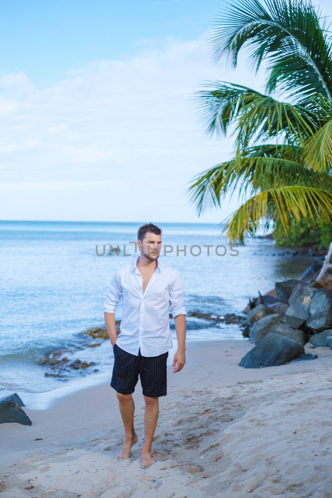 young men in swimshort on vacation Saint Lucia, luxury holiday Saint Lucia Caribbean by fokkebok