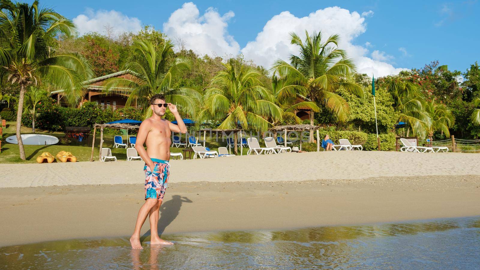 young men in a swim short on vacation in Saint Lucia, luxury holiday Saint Lucia Caribbean, men and woman on vacation at the tropical Island of Saint Lucia Caribbean. Calabash beach St Lucia Caribbean