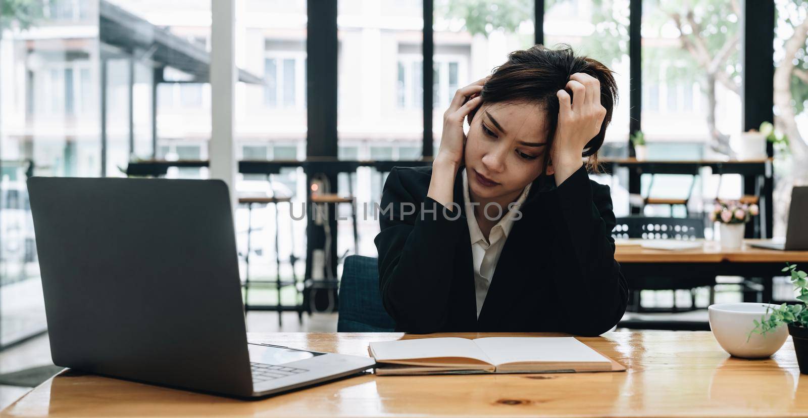 Tired asian business woman with headache at office, feeling sick at work.