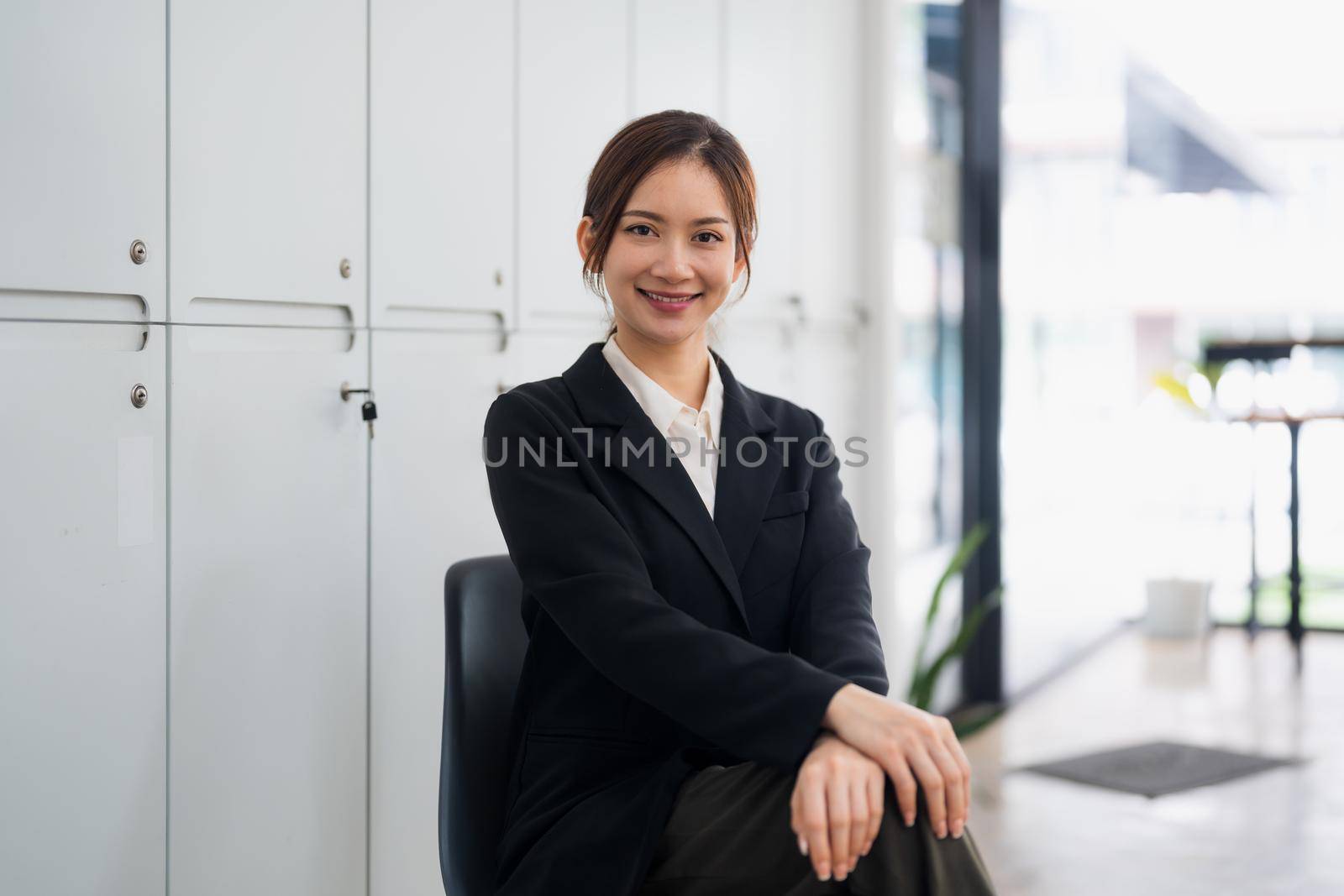 Portrait of smiling confident aisan female in office.