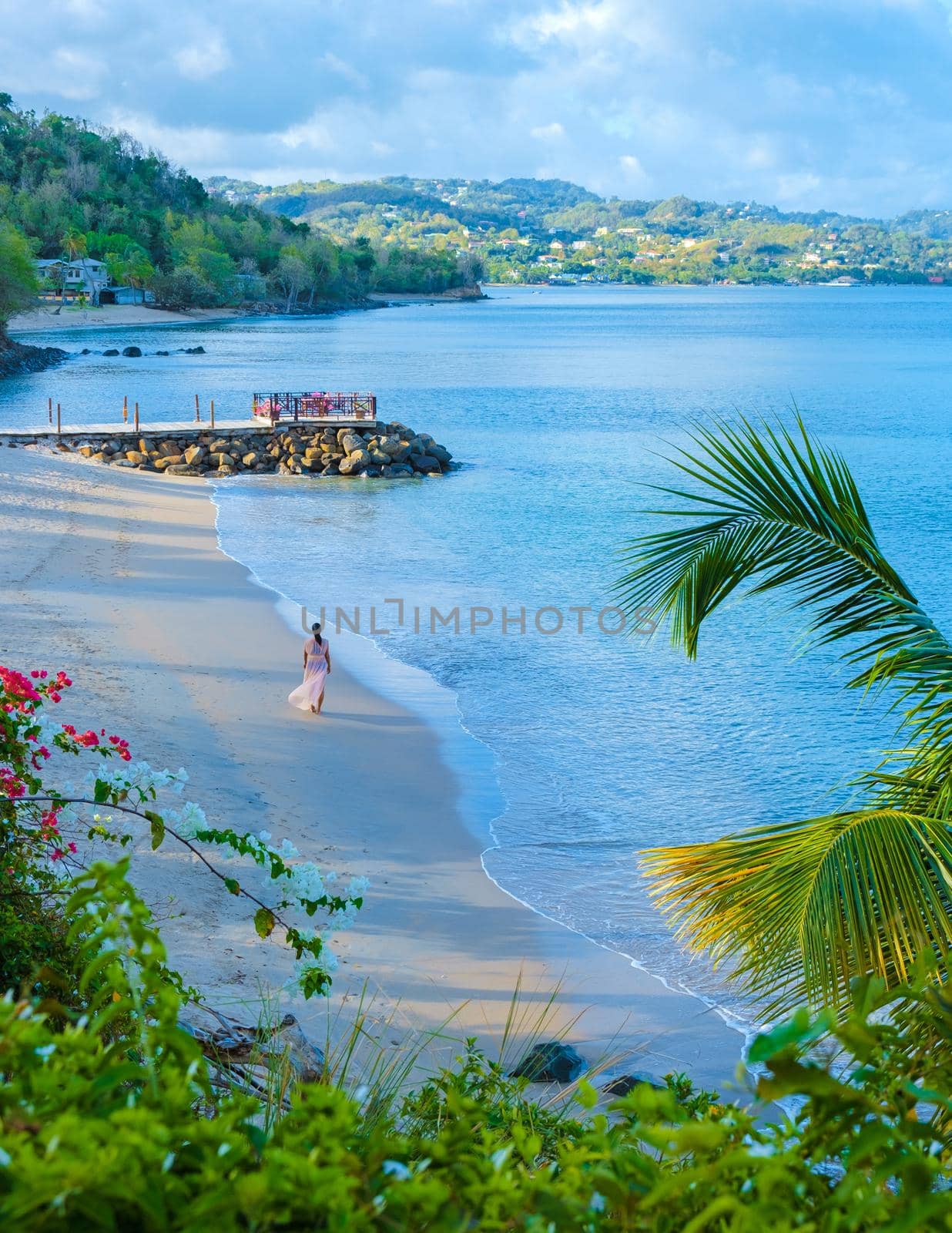 Asian women walking at the beach on vacation in Saint Lucia, luxury holiday Saint Lucia Caribbean, women on vacation at the tropical Island of Saint Lucia Caribbean. Calabash beach St Lucia Caribbean