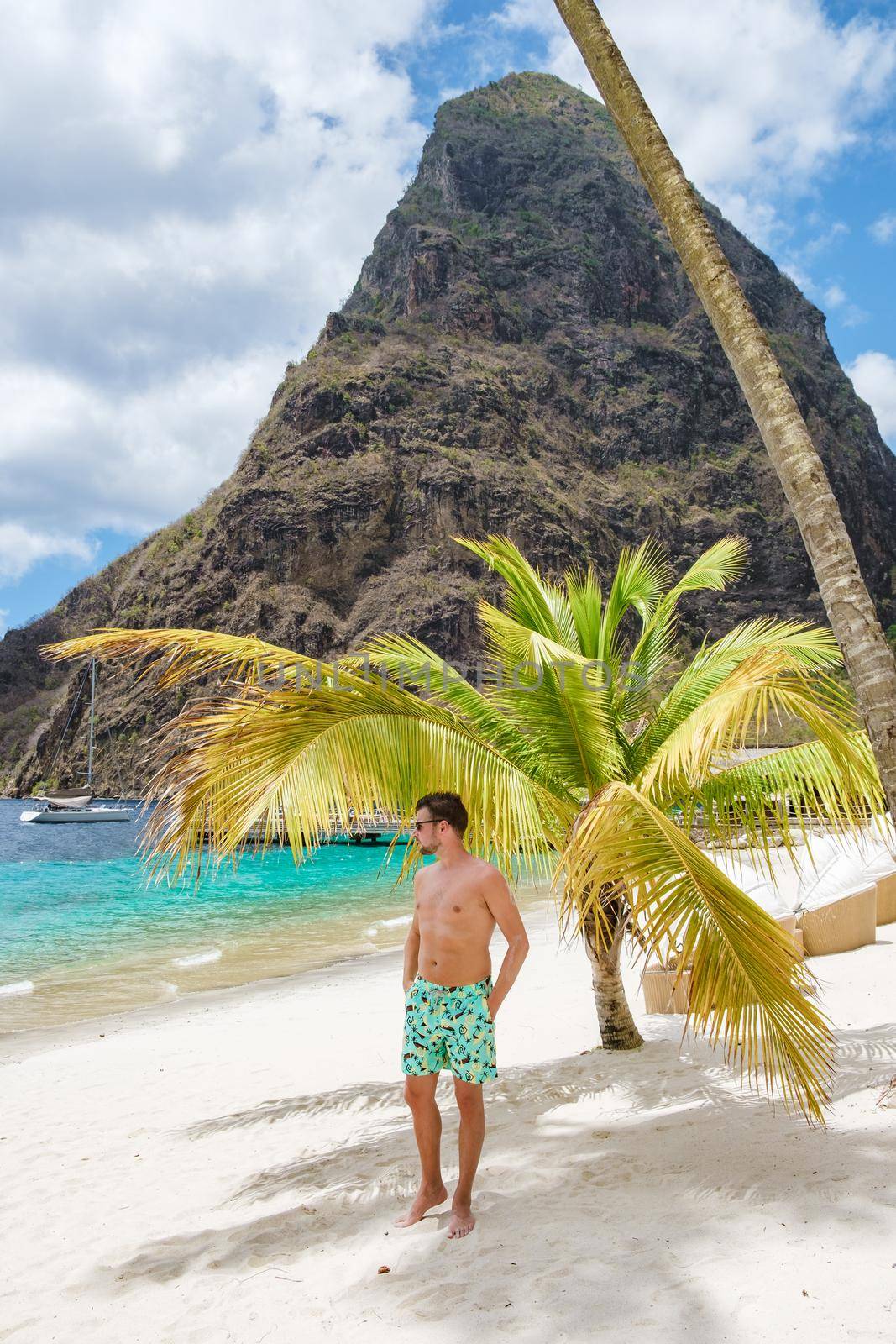 young men in a swim short on vacation in Saint Lucia, luxury holiday Saint Lucia Caribbean, men on vacation at the tropical Island of Saint Lucia Caribbean. Calabash beach St Lucia Caribbean