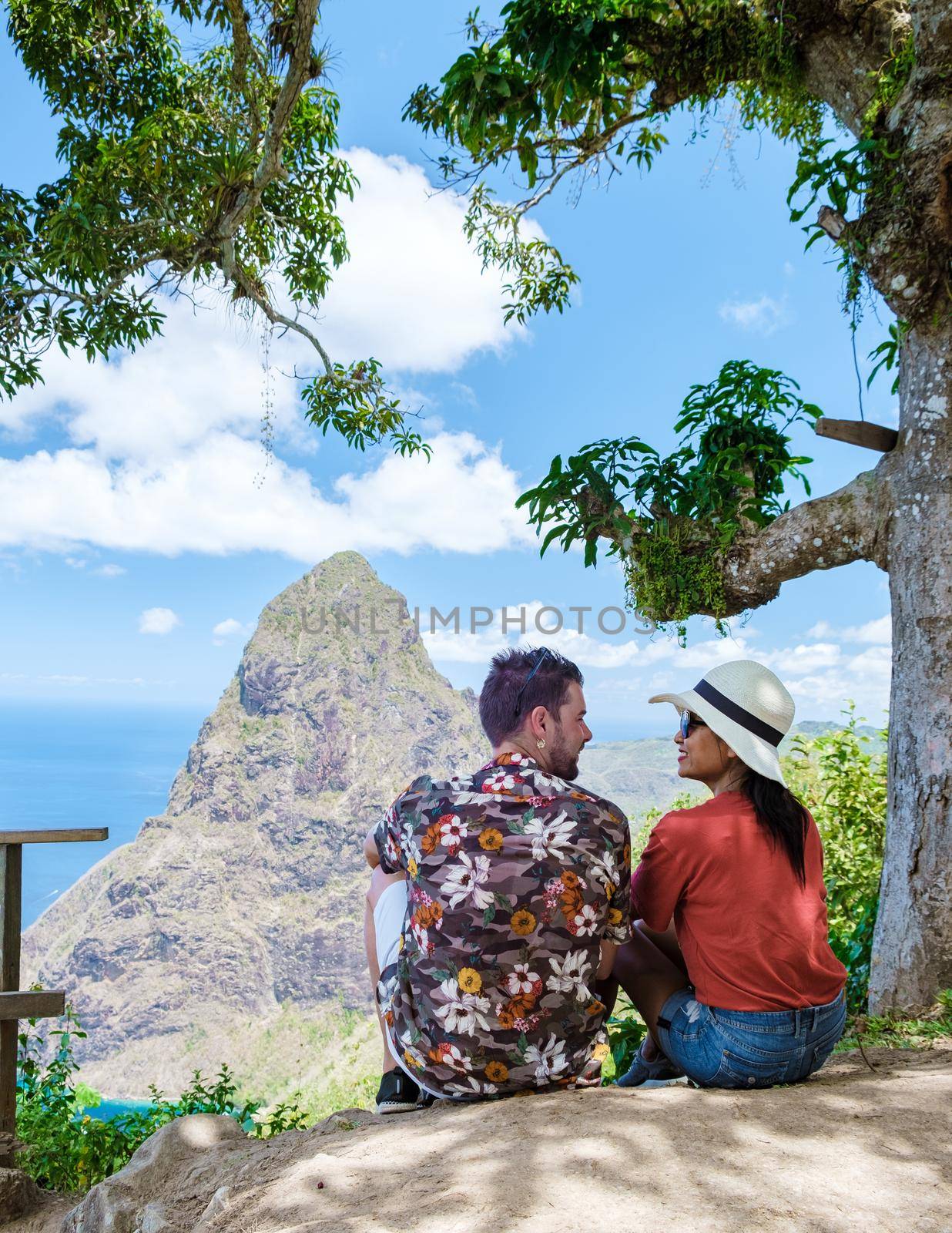 couple hiking in the mountains of Saint Lucia Caribbean, nature trail in the jungle of Saint Lucia with a look at the huge Pitons.