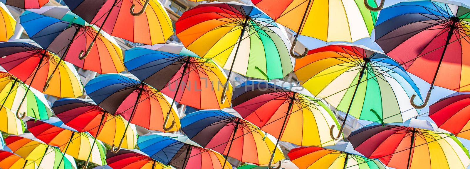 Colorful umbrellas Blue, green, red, rainbow umbrellas background Street with umbrellasin the sky Street decoration. by vikiriki