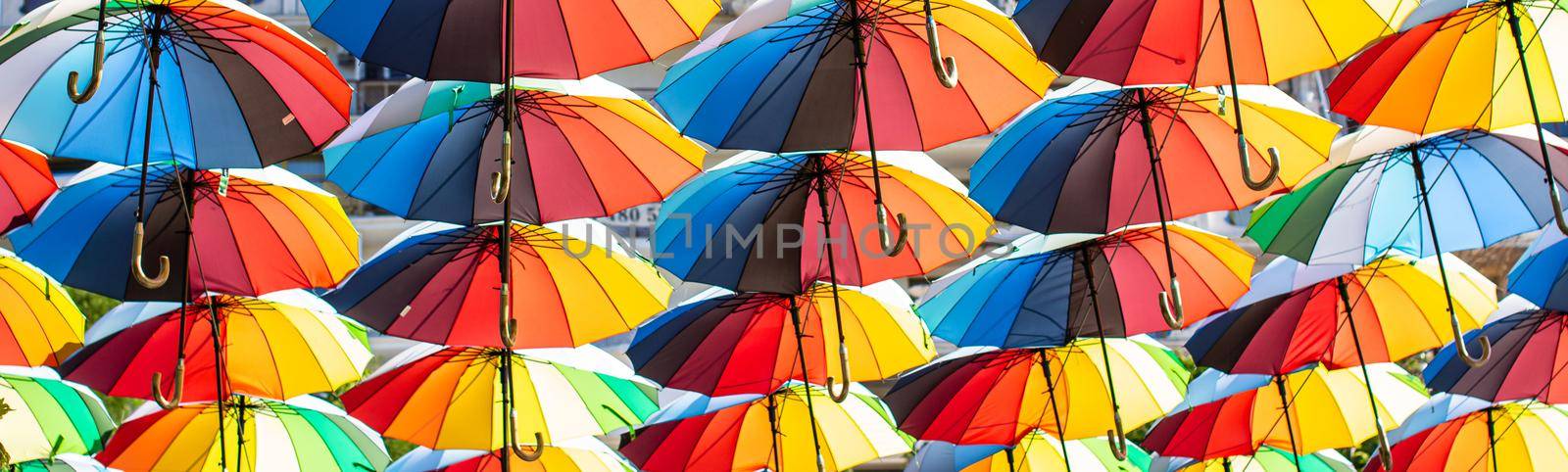 Colorful umbrellas Blue, green, red, rainbow umbrellas background Street with umbrellasin the sky Street decoration. by vikiriki