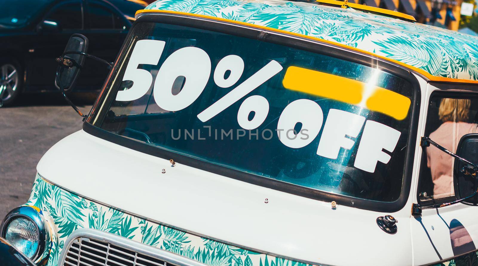 Sale 50% off Inscription 50% sale on the windshield of the bus