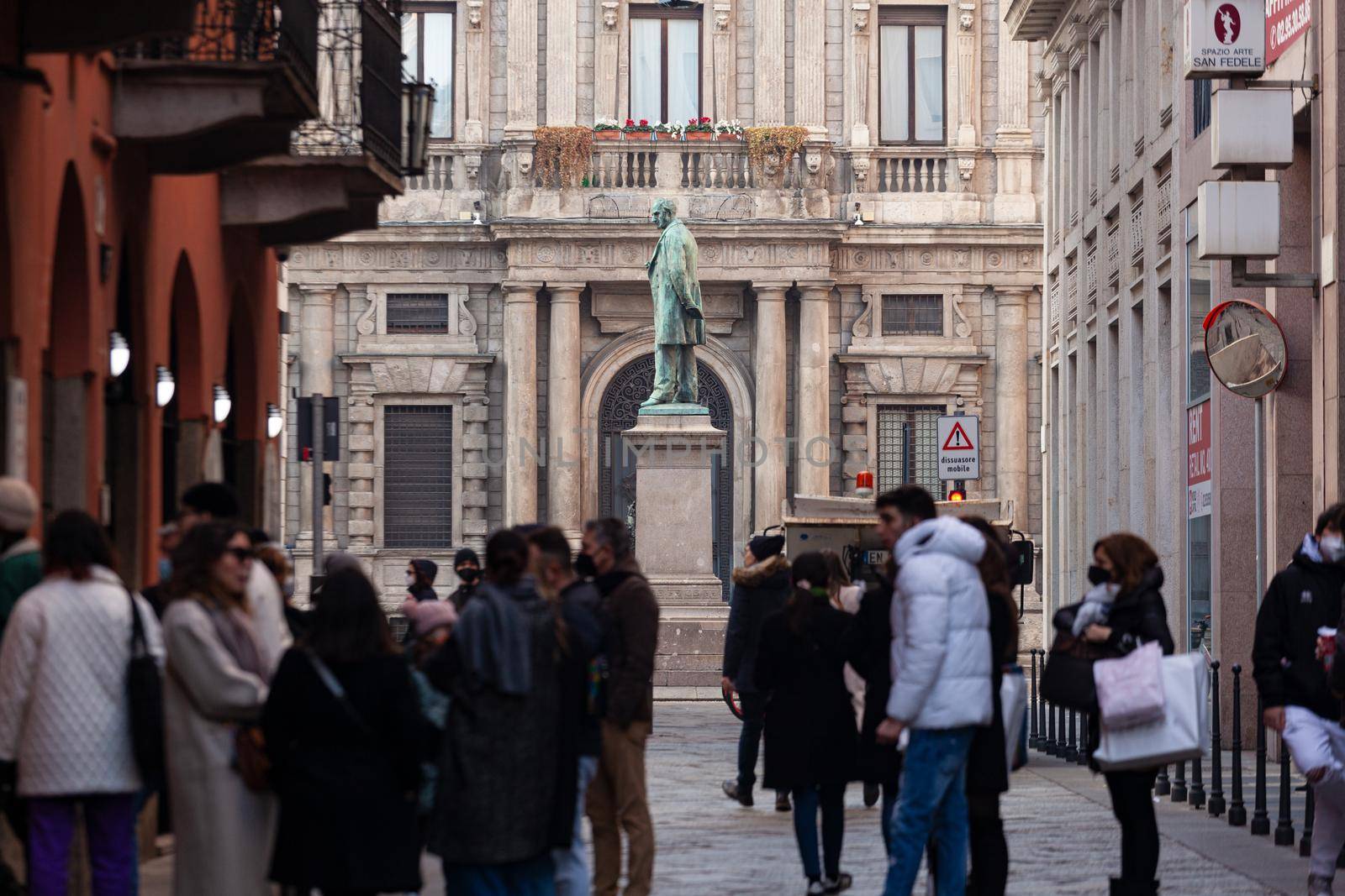 Pedestrians and cars on San Fedele square of Milan by bepsimage