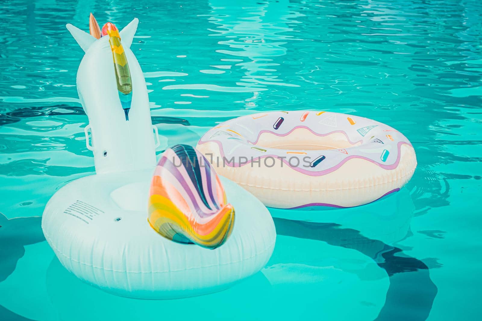 Yellow pool float, pool ring in cool blue refreshing blue pool