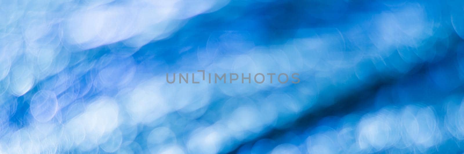 Blue abstract background with bokeh defocused lights by vikiriki