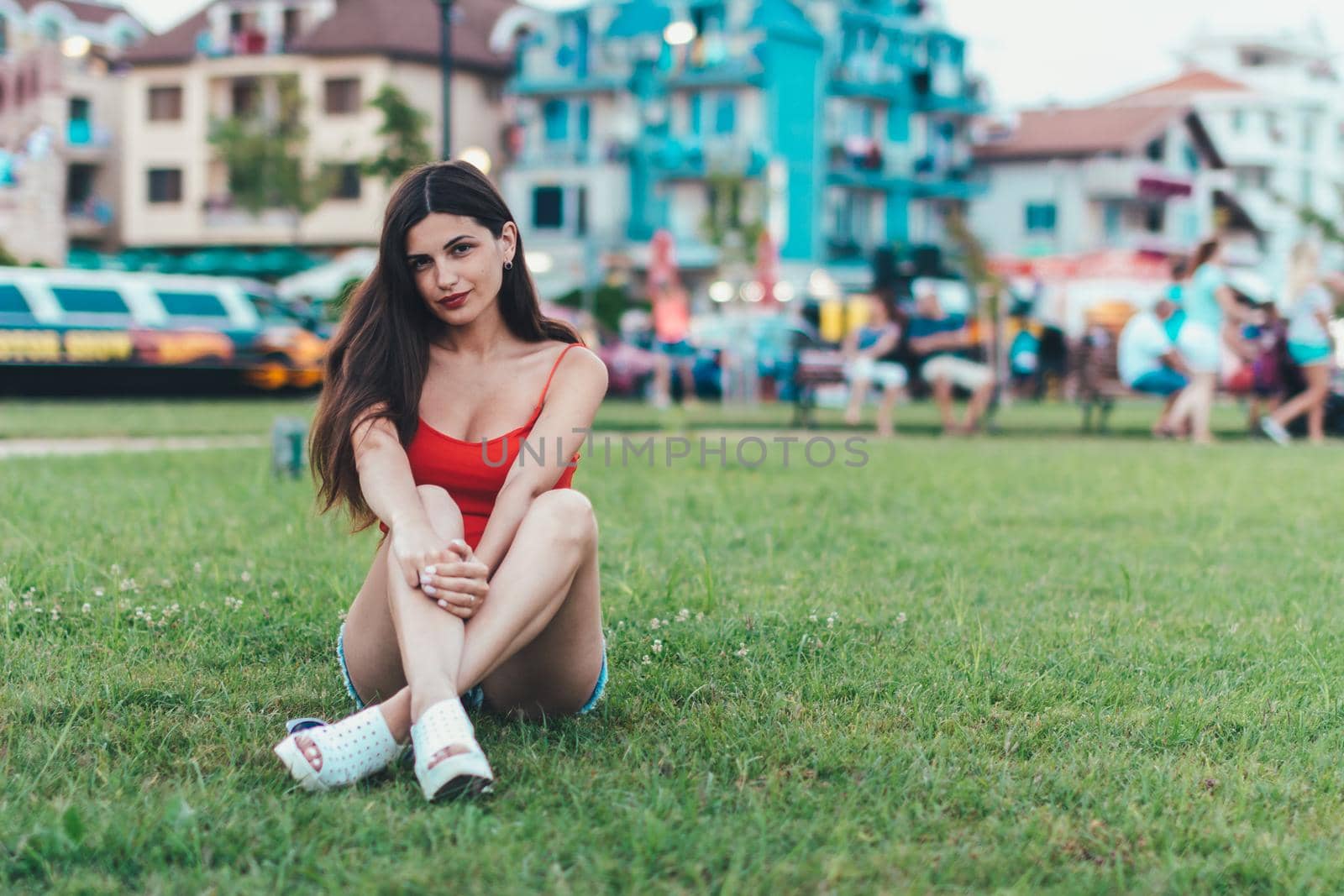 Girl relaxing on the lawn in a city park by vikiriki