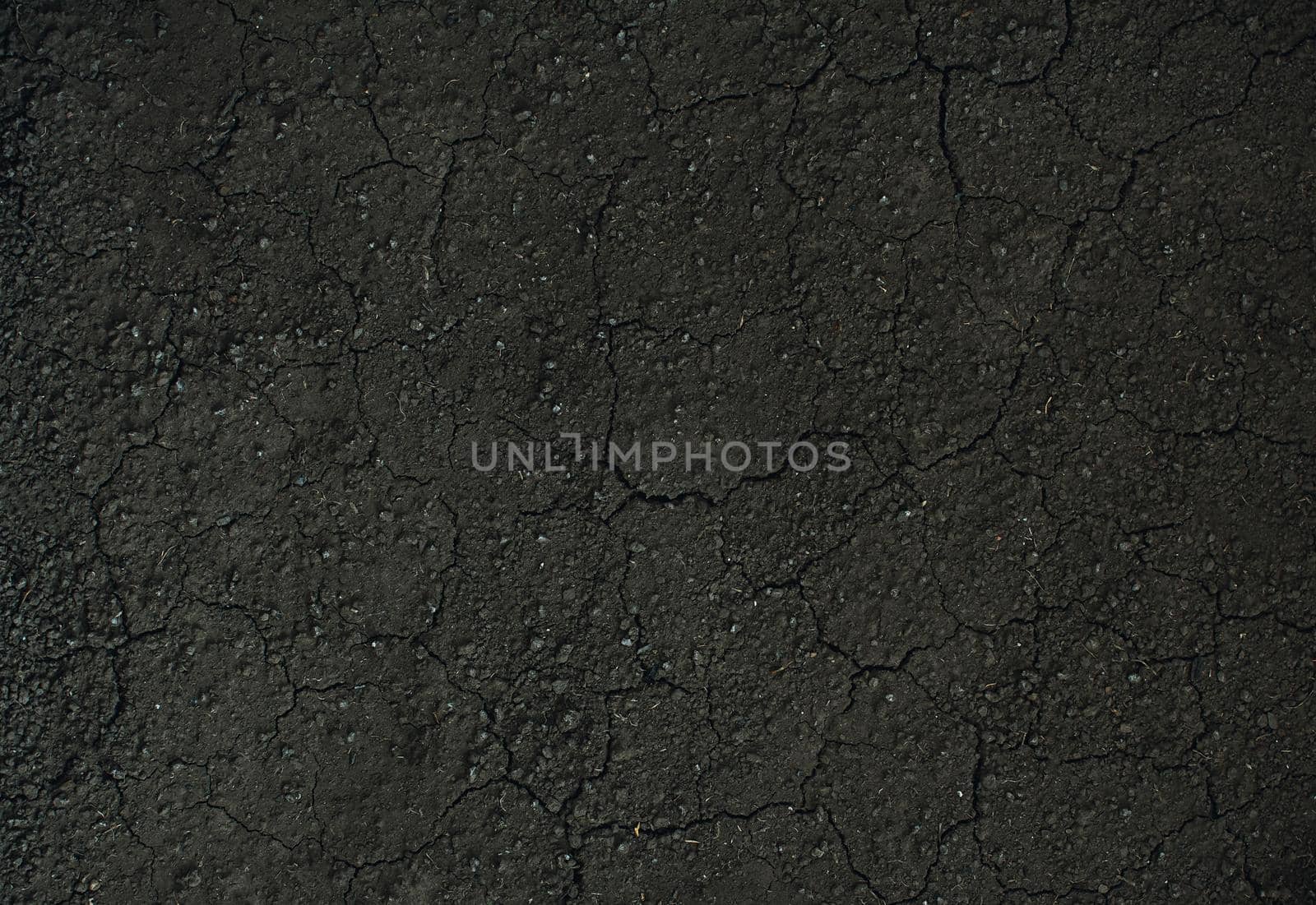 Dark soil texture closeup of dry soil background