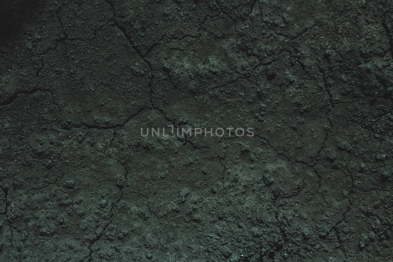 Dark soil texture closeup of dry soil background