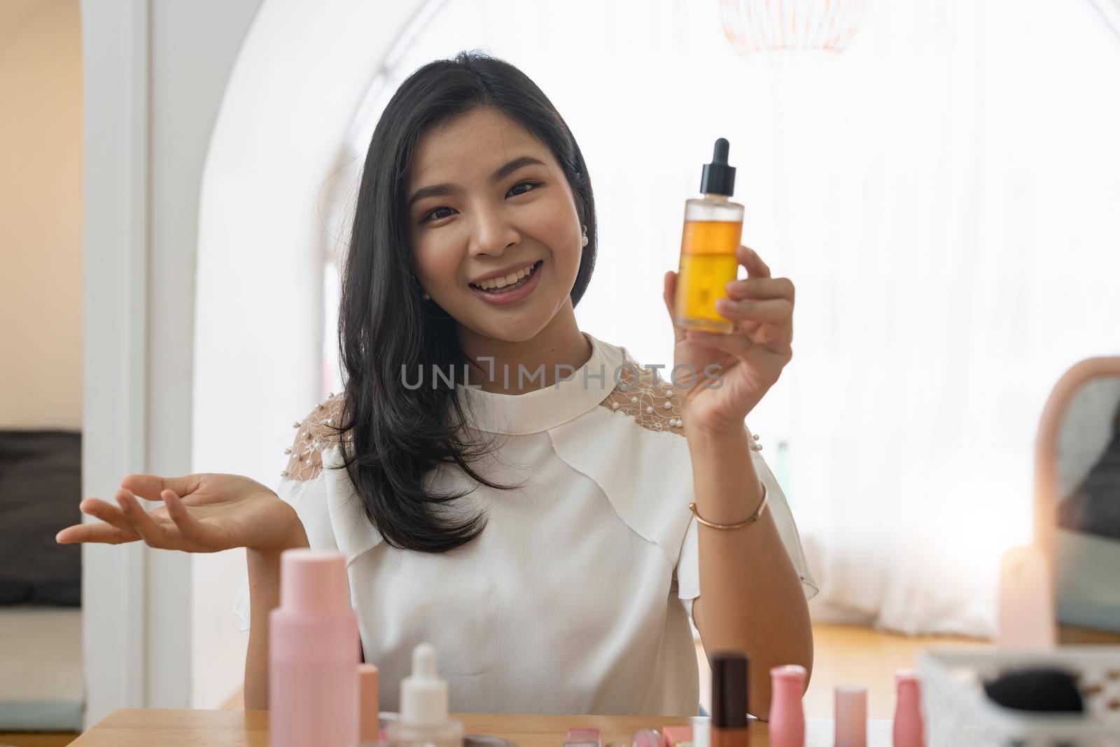 Young beautiful Asian woman and professional beauty make up artist vlogger or blogger recording makeup tutorial to share on website or social media. Business online influencer on social media concept