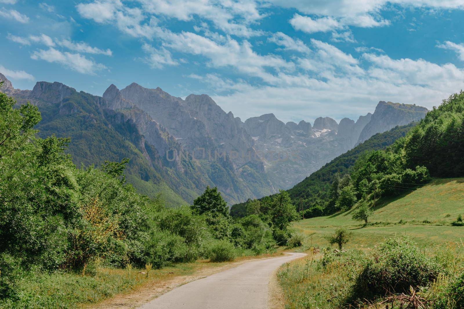 A view of the accursed mountains in the Grebaje Valley. Prokletije, also known as the Albanian Alps and the Accursed Mountains, is a mountain range on the Balkan peninsula, extending from northern Albania to Kosovo and eastern Montenegro by Andrii_Ko