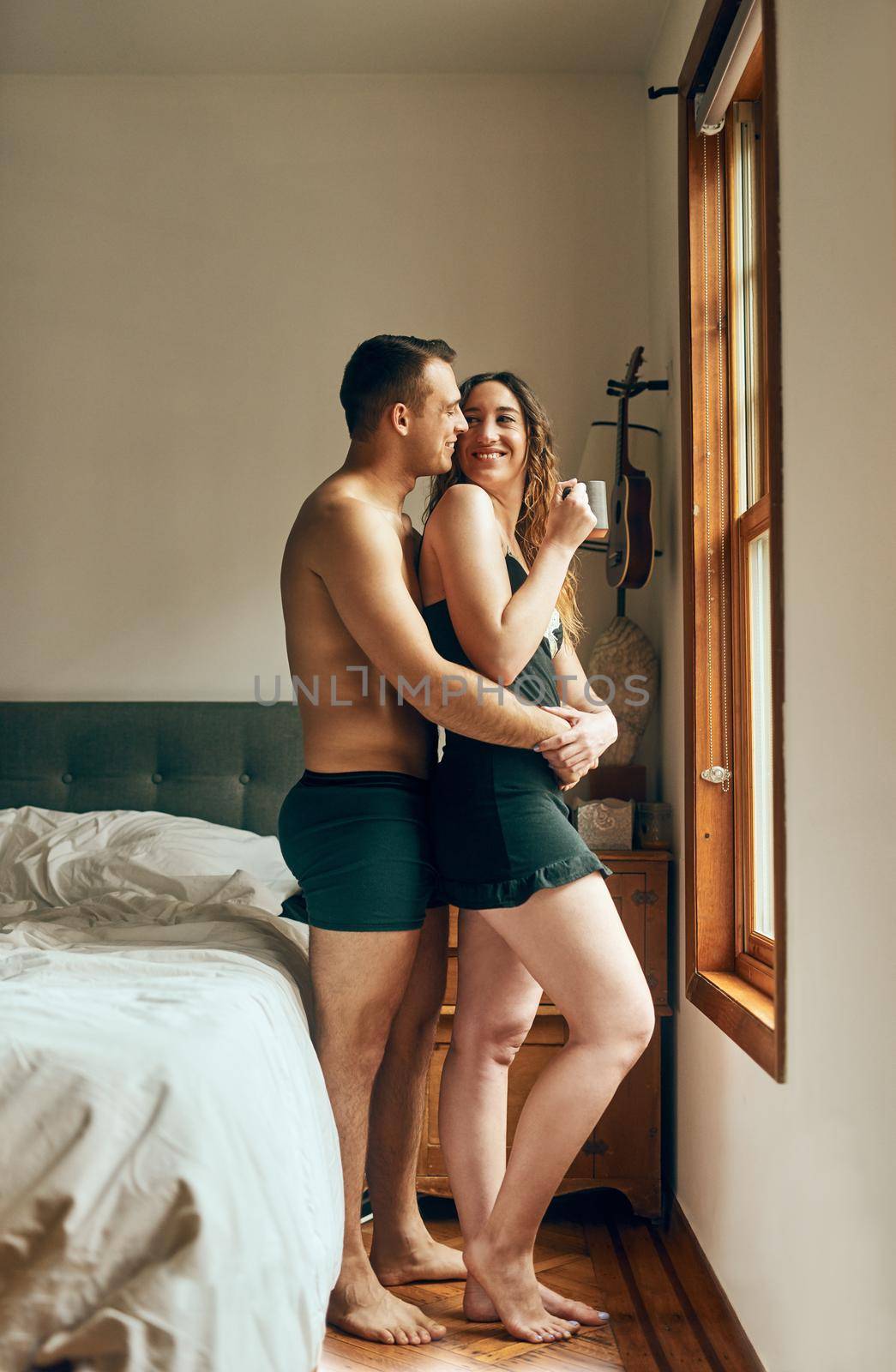 Romance makes the morning magical. an affectionate young couple having their morning coffee together in the bedroom at home