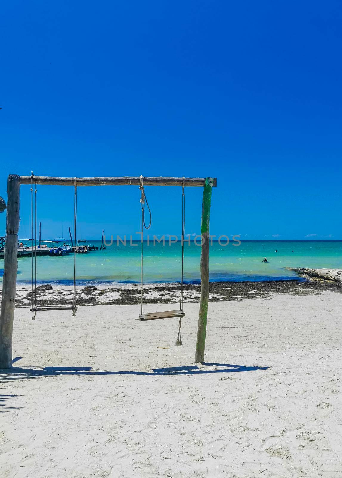 Panorama landscape view on beautiful Holbox island sandbank and beach with waves turquoise water and blue sky in Quintana Roo Mexico.