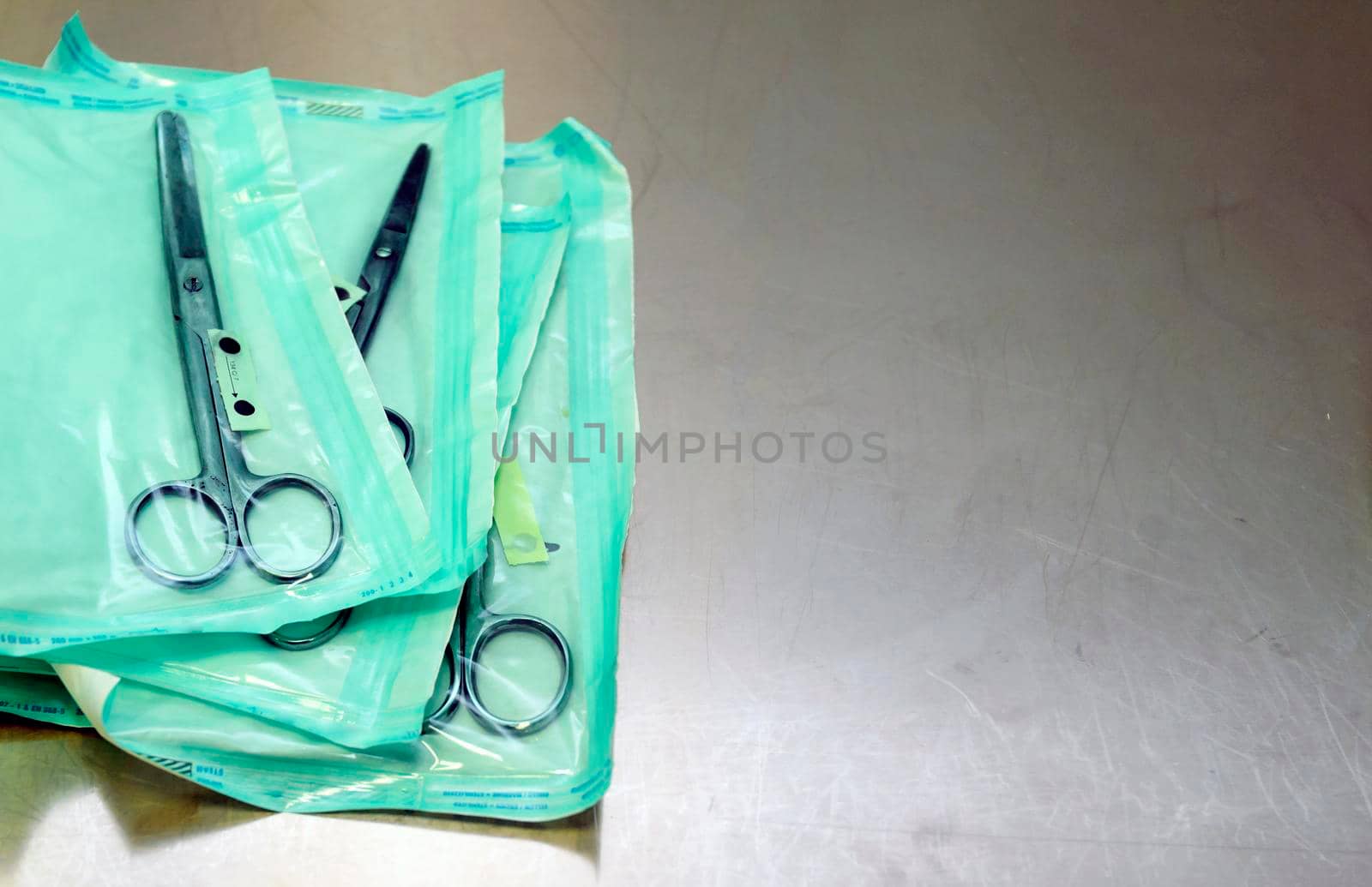 medical scissors on a table with a shallow depth of field in sterile bags.
