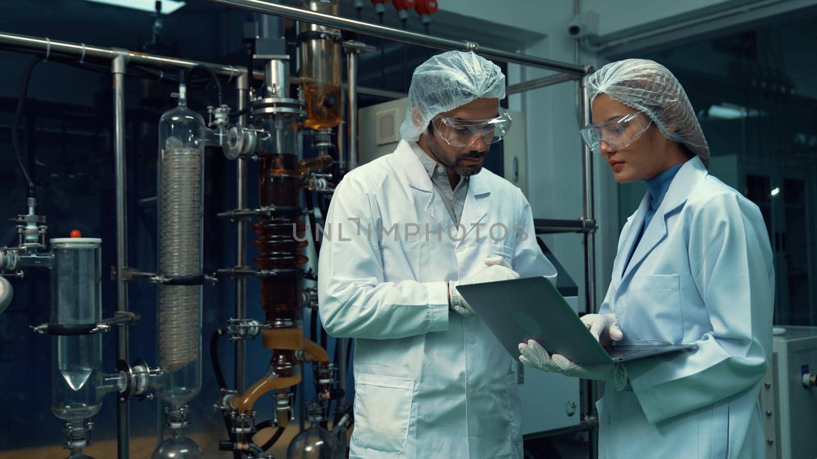 Two scientist in professional uniform working in laboratory for chemical and biomedical experiment