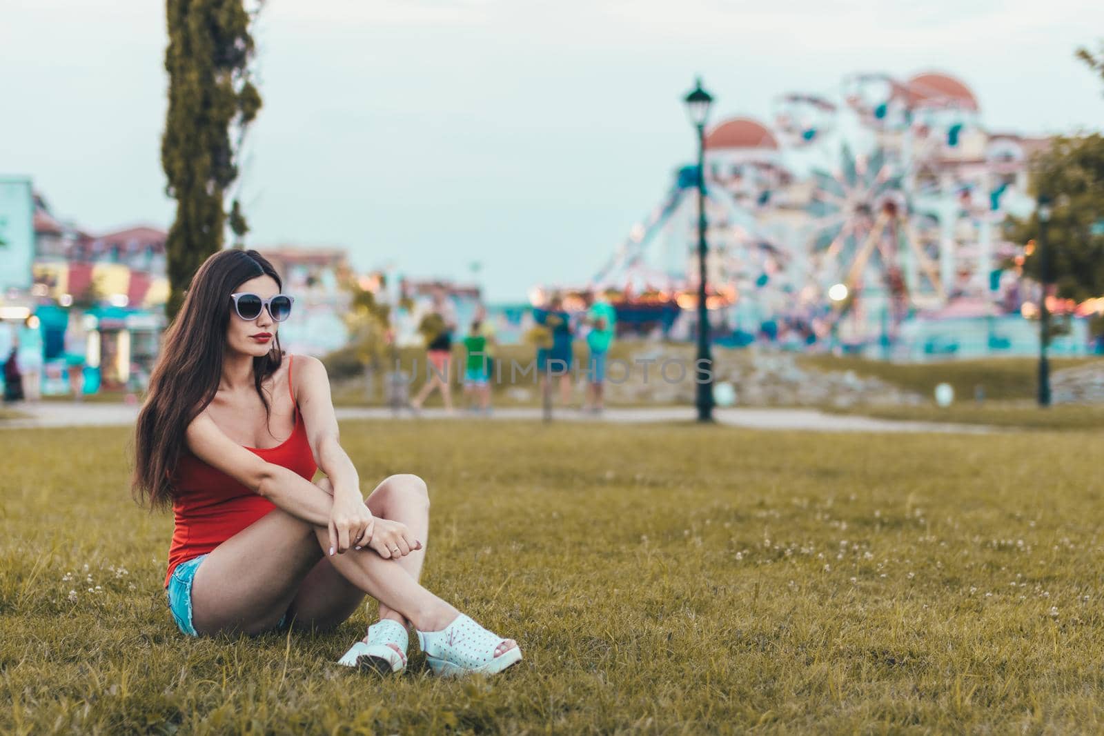 Girl relaxing on the lawn in a city park