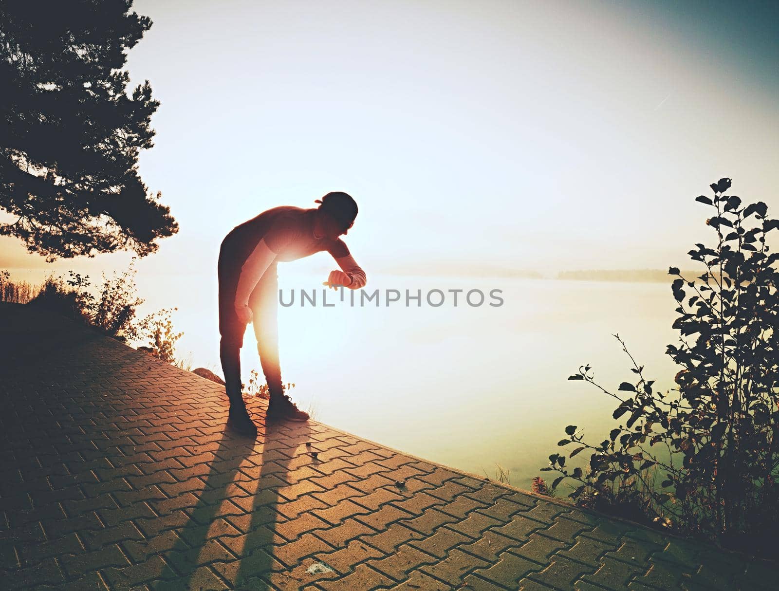 Runner during run using his wearable technology smartwatch  by rdonar2