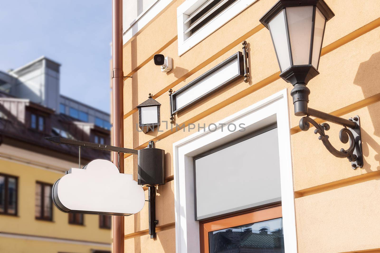 mockup, white signboard, in the form of a cloud, classic style. for a restaurant or cafe on the house, against the backdrop of the old city street. open a sign style to add a sign or company logo