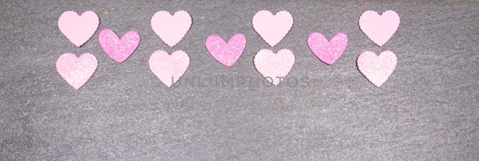 gray granite background with pink and white hearts for valentines day. Valentine's day and love concept by jp_chretien