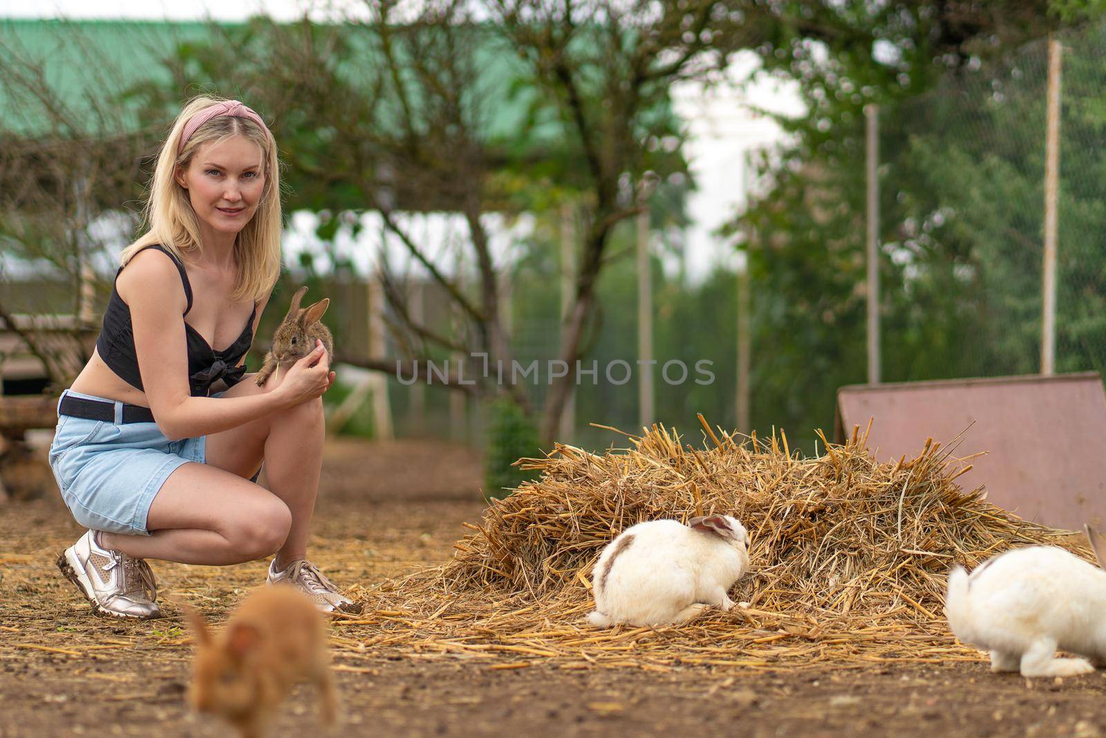 Girl feeds easter rabbit parsley brown bunny white fluffy garden, concept group young for portrait from furry fur, ear bright. Funny isolated,