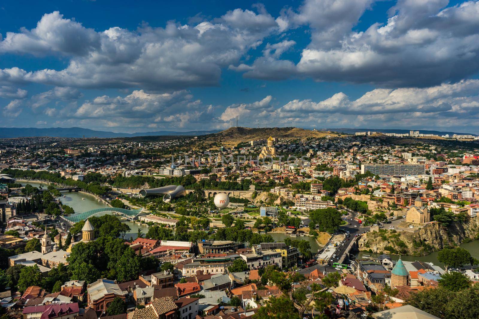 Tbilisi's cityscape with overview of Old town medieval architecture and Downtown with modern skyscarpers