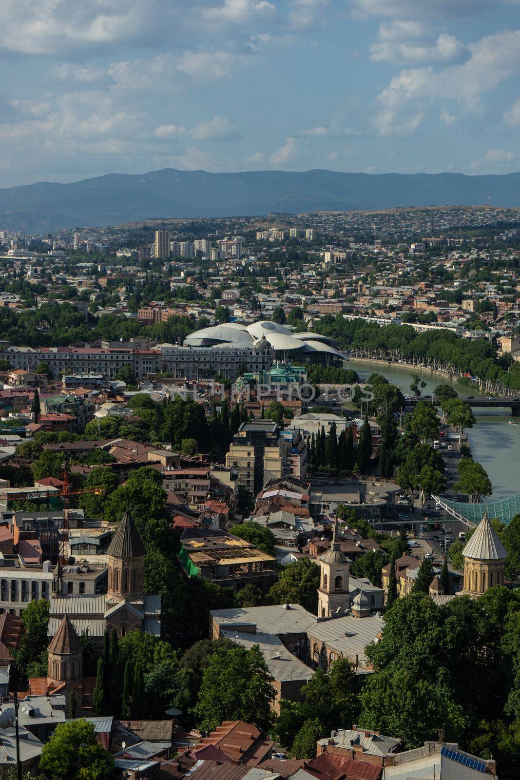 Tbilisi's cityscape with overview of Old town medieval architecture and Downtown with modern skyscarpers