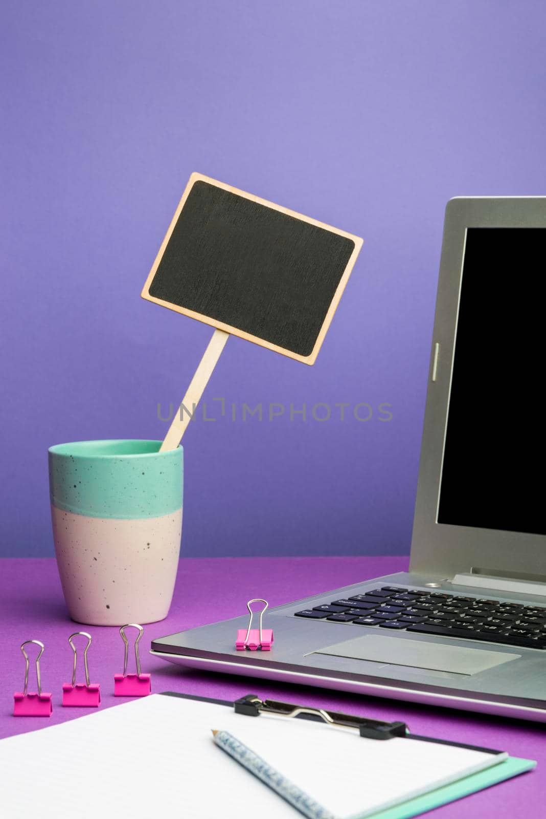 Lap Top With Important Information On Table With Plant And Cup Of Coffee.