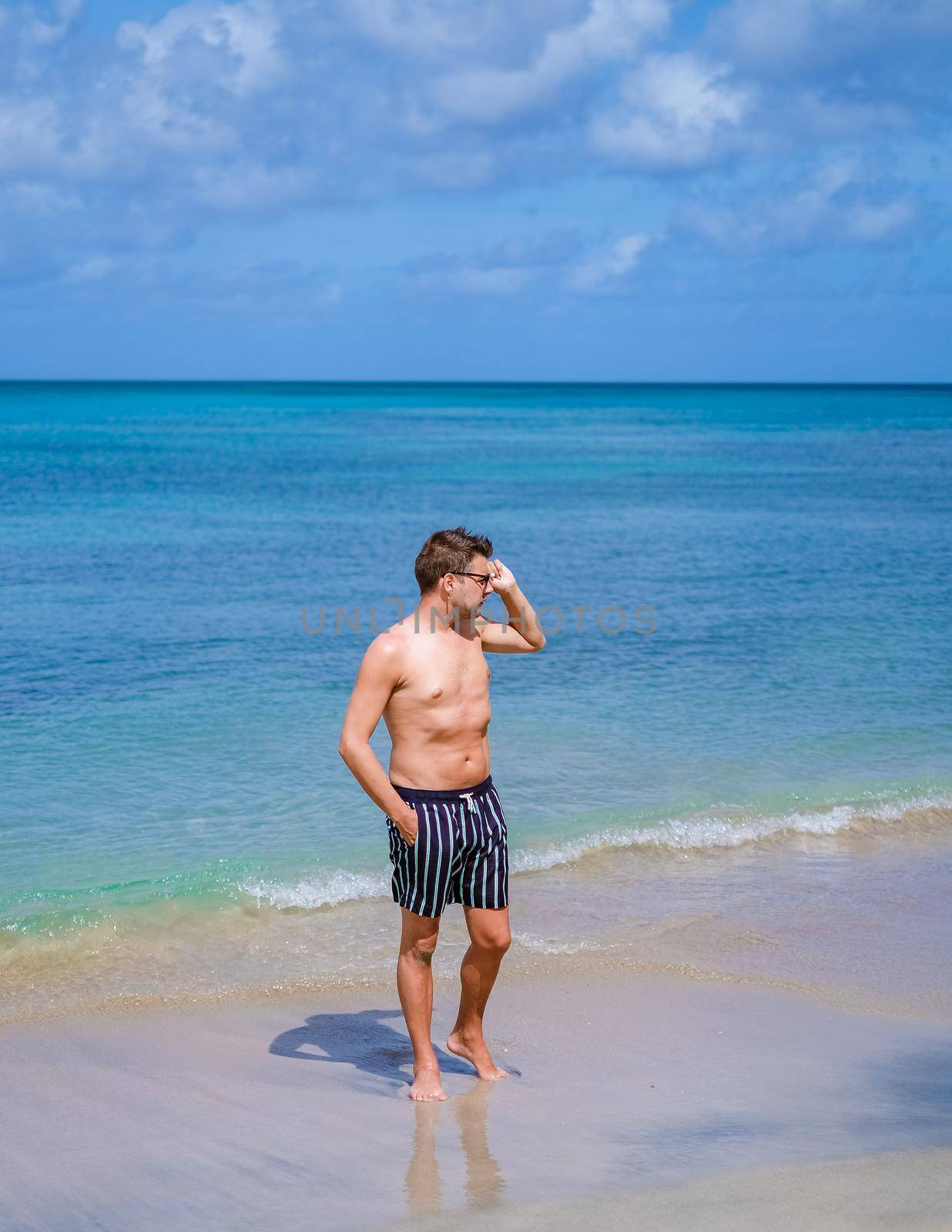 young men in swimshort on vacation Saint Lucia, luxury holiday Saint Lucia Caribbean by fokkebok