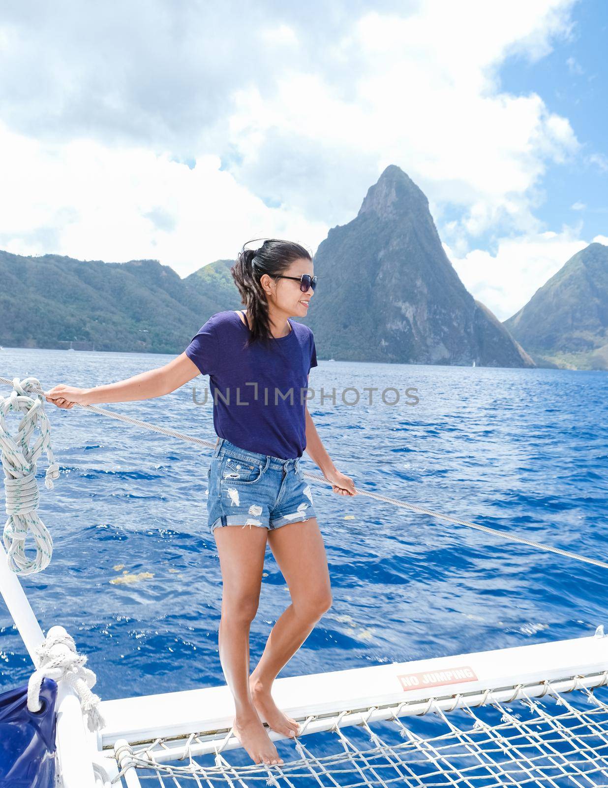 young women on a boat trip with a catamaran on vacation in Saint Lucia, luxury holiday Saint Lucia Caribbean, and Asian women on vacation at the tropical Island of Saint Lucia Caribbean.