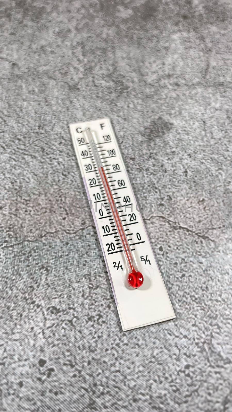 thermometer on the grey background by yilmazsavaskandag