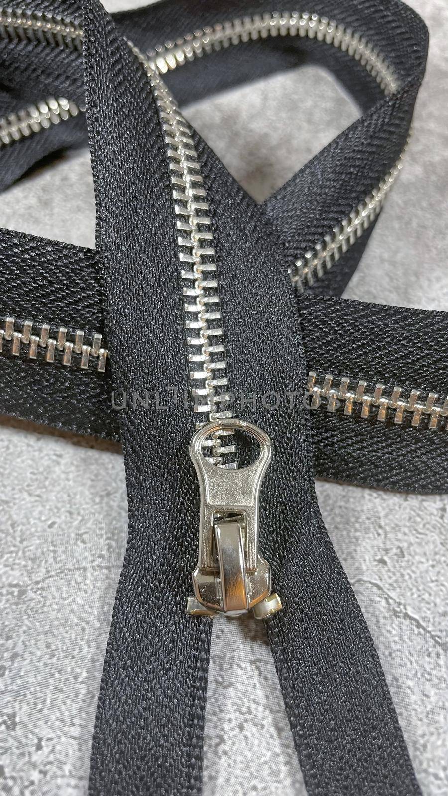 black zipper on the grey background by yilmazsavaskandag